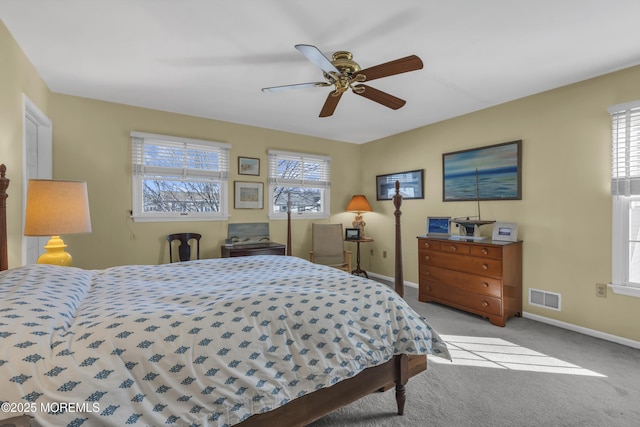 bedroom featuring multiple windows, light carpet, and ceiling fan