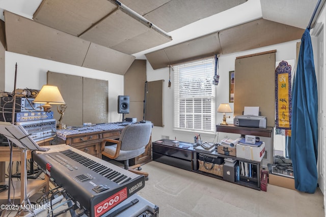 carpeted home office with lofted ceiling