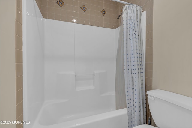 bathroom with toilet and shower / bath combo with shower curtain