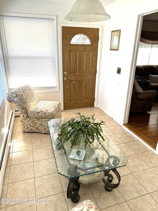 entryway featuring a baseboard heating unit and light tile patterned floors