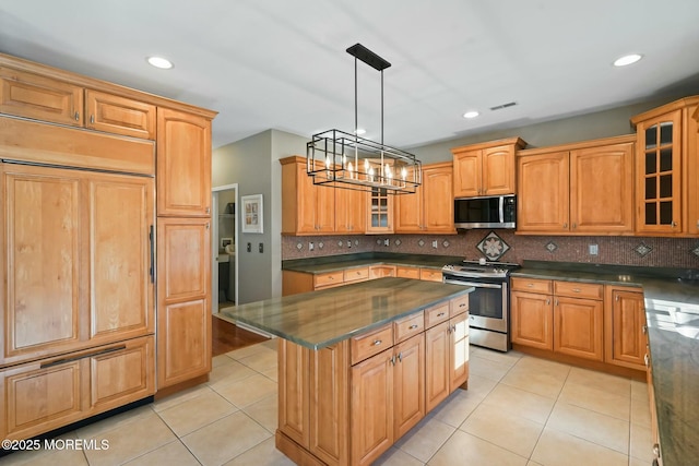 kitchen with a kitchen island, appliances with stainless steel finishes, pendant lighting, and light tile patterned floors