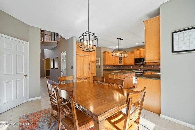 tiled dining room with a notable chandelier