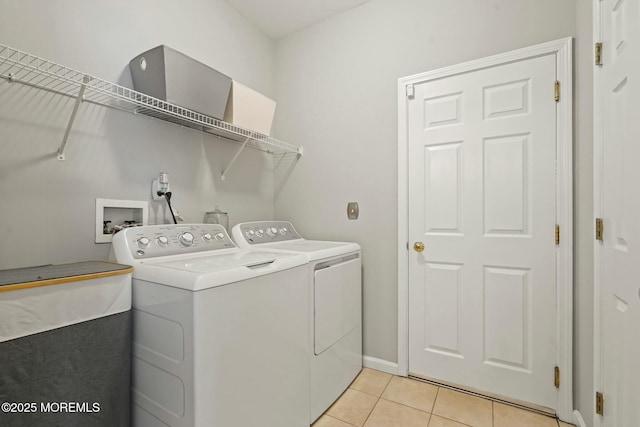 washroom with independent washer and dryer and light tile patterned floors