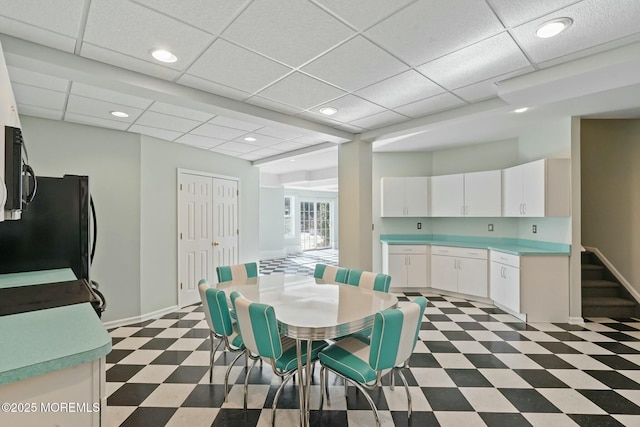 dining room featuring a drop ceiling