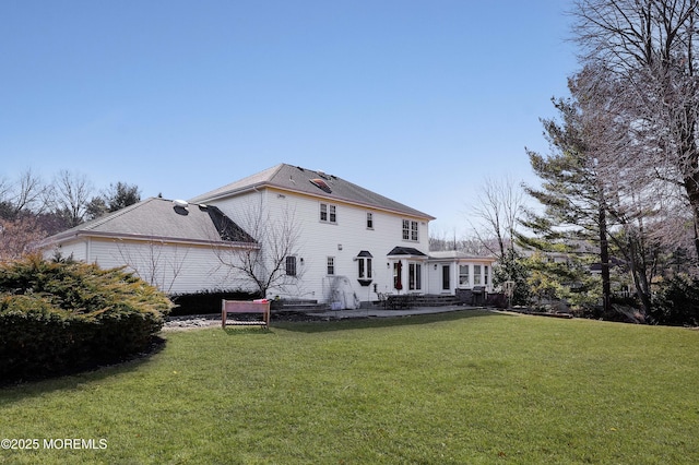 rear view of property featuring a yard