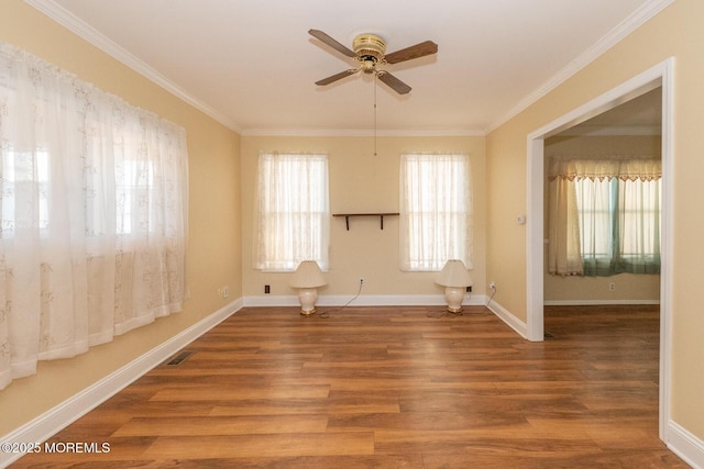 empty room with crown molding, hardwood / wood-style flooring, and ceiling fan