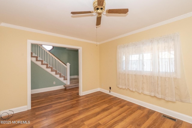 spare room featuring crown molding and hardwood / wood-style floors