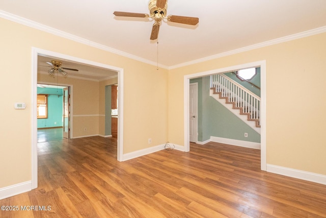 empty room with wood-type flooring, ceiling fan, and crown molding