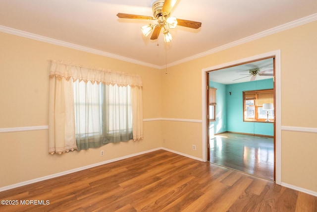 empty room featuring crown molding, hardwood / wood-style flooring, and ceiling fan