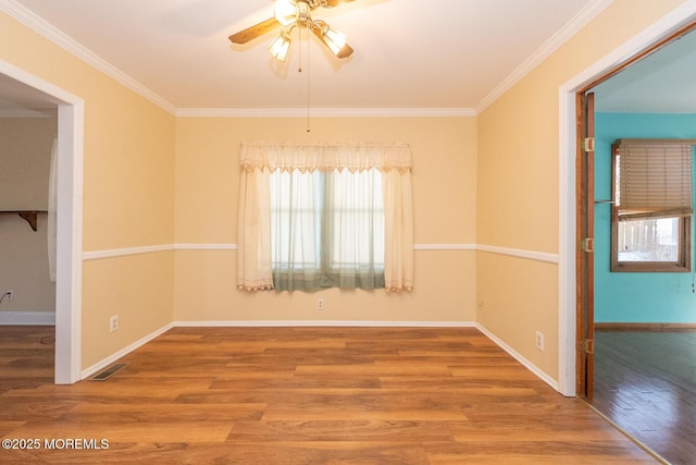 unfurnished room featuring hardwood / wood-style flooring, ornamental molding, and ceiling fan