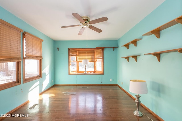 spare room featuring hardwood / wood-style floors and ceiling fan