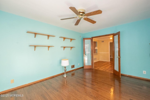 spare room with french doors, ceiling fan, and wood-type flooring