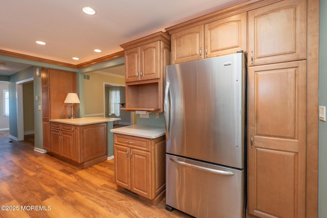 kitchen with stainless steel refrigerator and light wood-type flooring