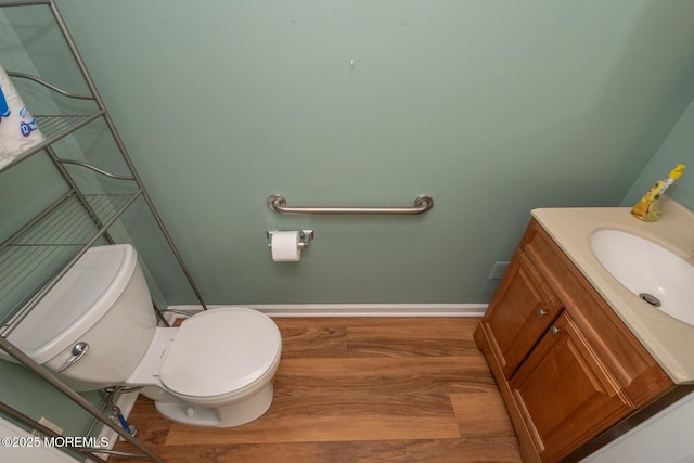 bathroom featuring vanity, toilet, and hardwood / wood-style floors