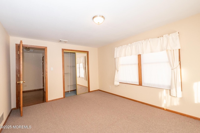 unfurnished bedroom with carpet and a closet