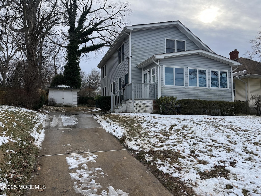 view of front property with a shed