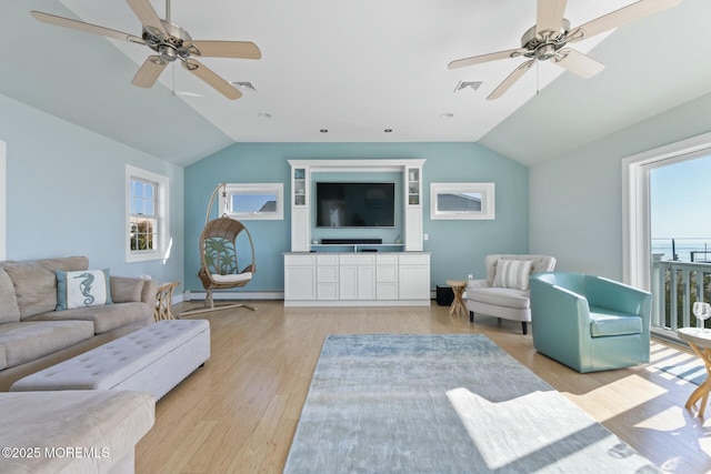 living room featuring vaulted ceiling, a baseboard heating unit, ceiling fan, and light wood-type flooring