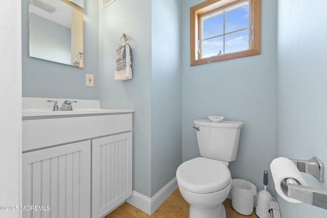 bathroom featuring hardwood / wood-style flooring, vanity, and toilet