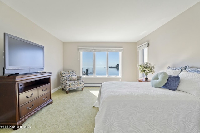 bedroom featuring light colored carpet and baseboard heating