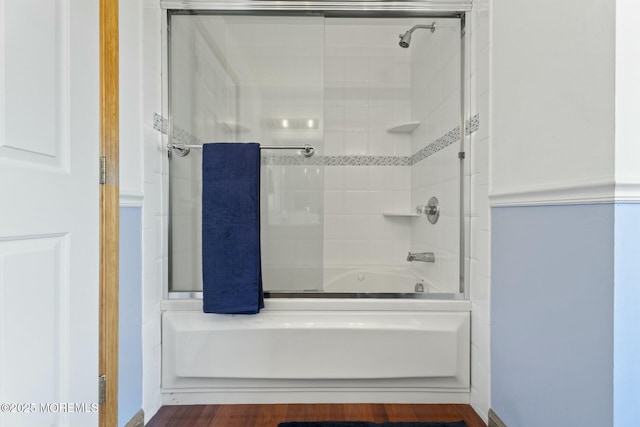 bathroom featuring bath / shower combo with glass door