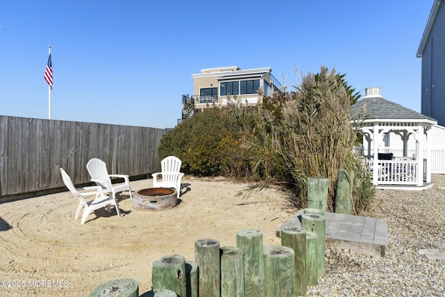 view of yard featuring a gazebo and an outdoor fire pit