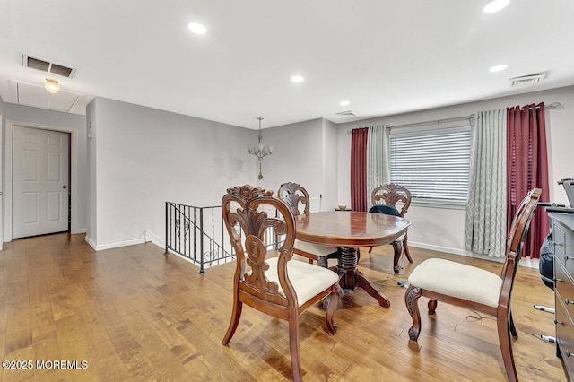 dining room featuring a notable chandelier and light hardwood / wood-style floors