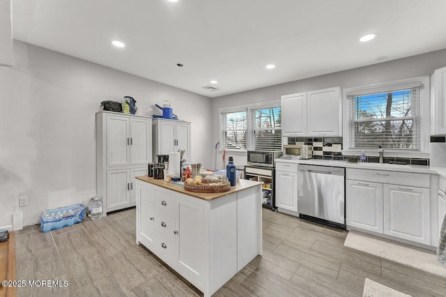 kitchen featuring white cabinets and appliances with stainless steel finishes