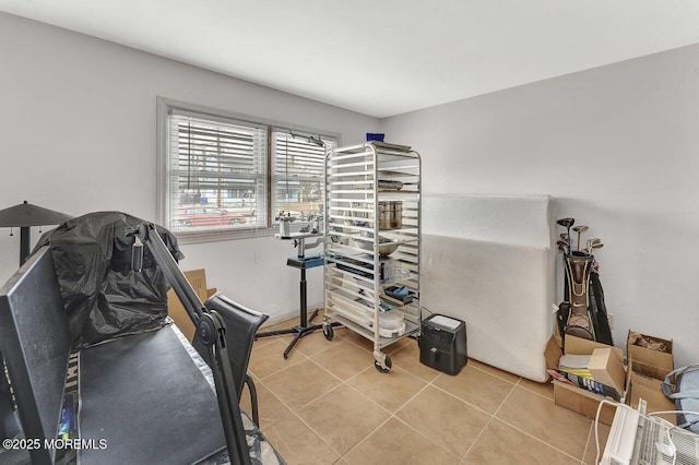 exercise room featuring light tile patterned floors