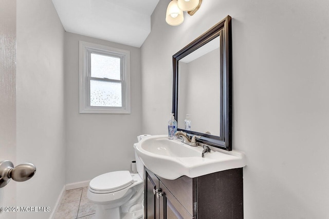 bathroom with toilet, tile patterned floors, and vanity