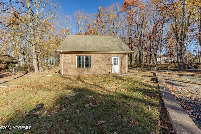 view of outbuilding featuring a lawn