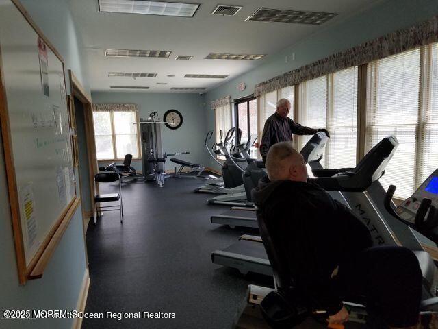 exercise room featuring visible vents and a healthy amount of sunlight