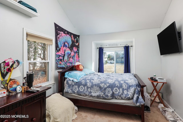 bedroom featuring lofted ceiling and carpet flooring