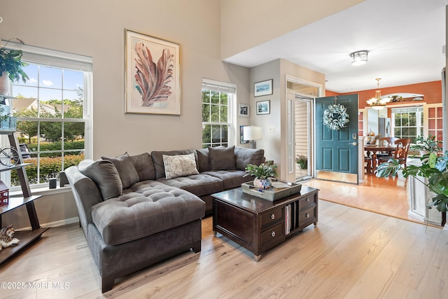 66 Banyan Blvd, Holmdel, NJ 07733 - living area featuring a chandelier, light wood-style flooring, and plenty of natural light
