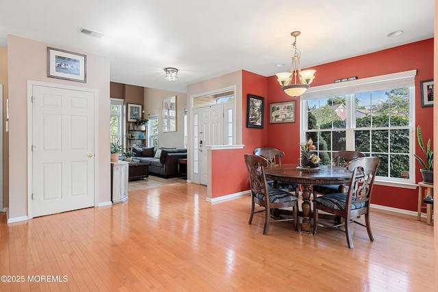 66 Banyan Blvd, Holmdel, NJ 07733 - dining room featuring light wood-style flooring, a chandelier, and healthy amount of natural light