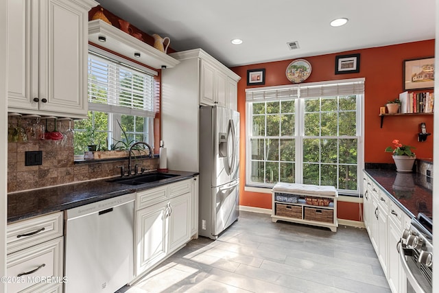 66 Banyan Blvd, Holmdel, NJ 07733 - kitchen featuring stainless steel appliances, decorative backsplash, recessed lighting, white cabinetry, and dark stone countertops