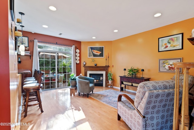 66 Banyan Blvd, Holmdel, NJ 07733 - living room with recessed lighting, a fireplace with flush hearth, and wood finished floors