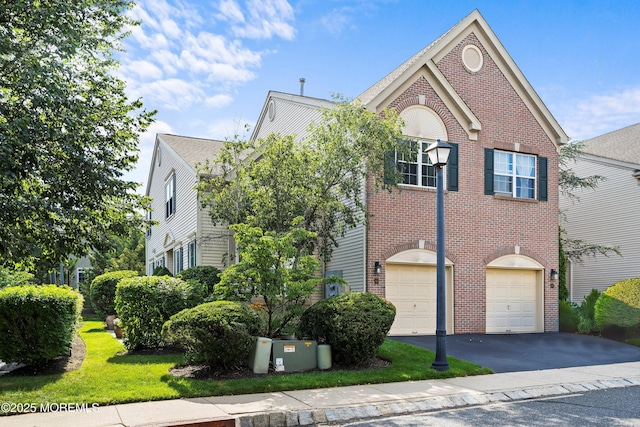 66 Banyan Blvd, Holmdel, NJ 07733 - view of front facade featuring driveway, brick siding, and a garage