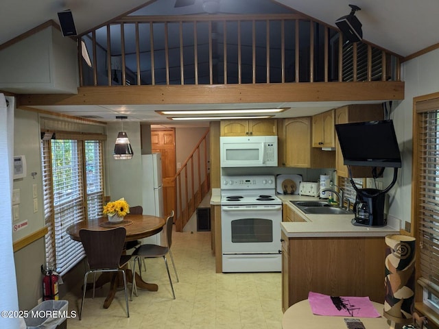 kitchen featuring sink, white appliances, and decorative light fixtures