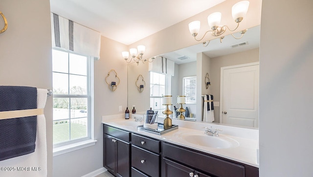 bathroom with vanity and a chandelier