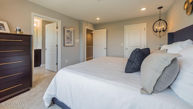 bedroom with light colored carpet and a chandelier