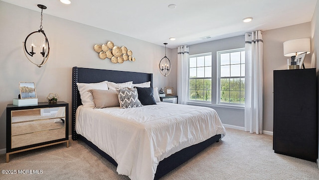 bedroom featuring carpet flooring and a notable chandelier