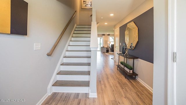 stairs with hardwood / wood-style flooring