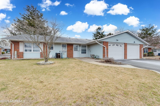 ranch-style house with a garage, central AC, and a front yard