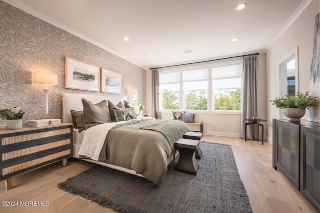 bedroom featuring multiple windows, crown molding, and light hardwood / wood-style floors