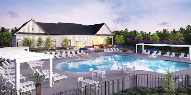 pool at dusk featuring a pergola and a patio area