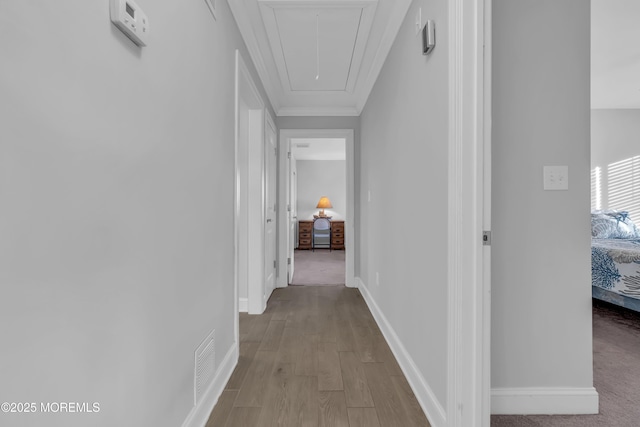 hallway featuring ornamental molding and light wood-type flooring