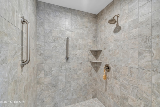 bathroom with a tile shower