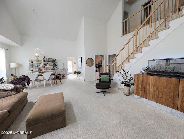 living room with carpet flooring and high vaulted ceiling