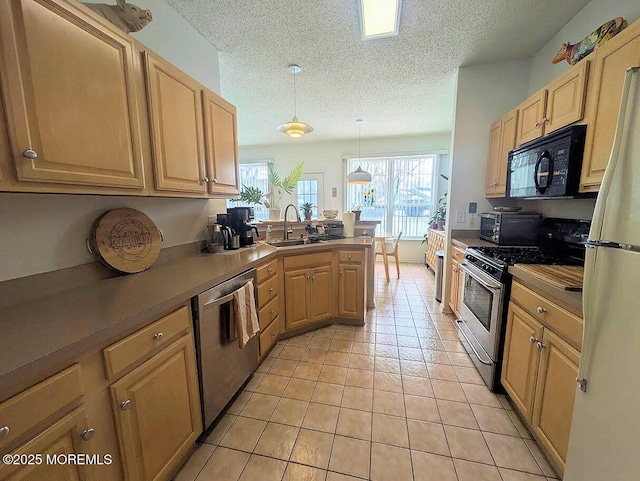 kitchen with hanging light fixtures, sink, light tile patterned flooring, a textured ceiling, and stainless steel appliances