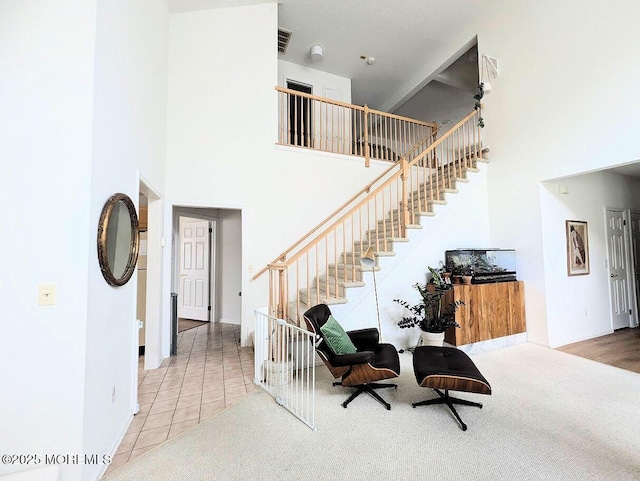 interior space with a high ceiling and tile patterned floors